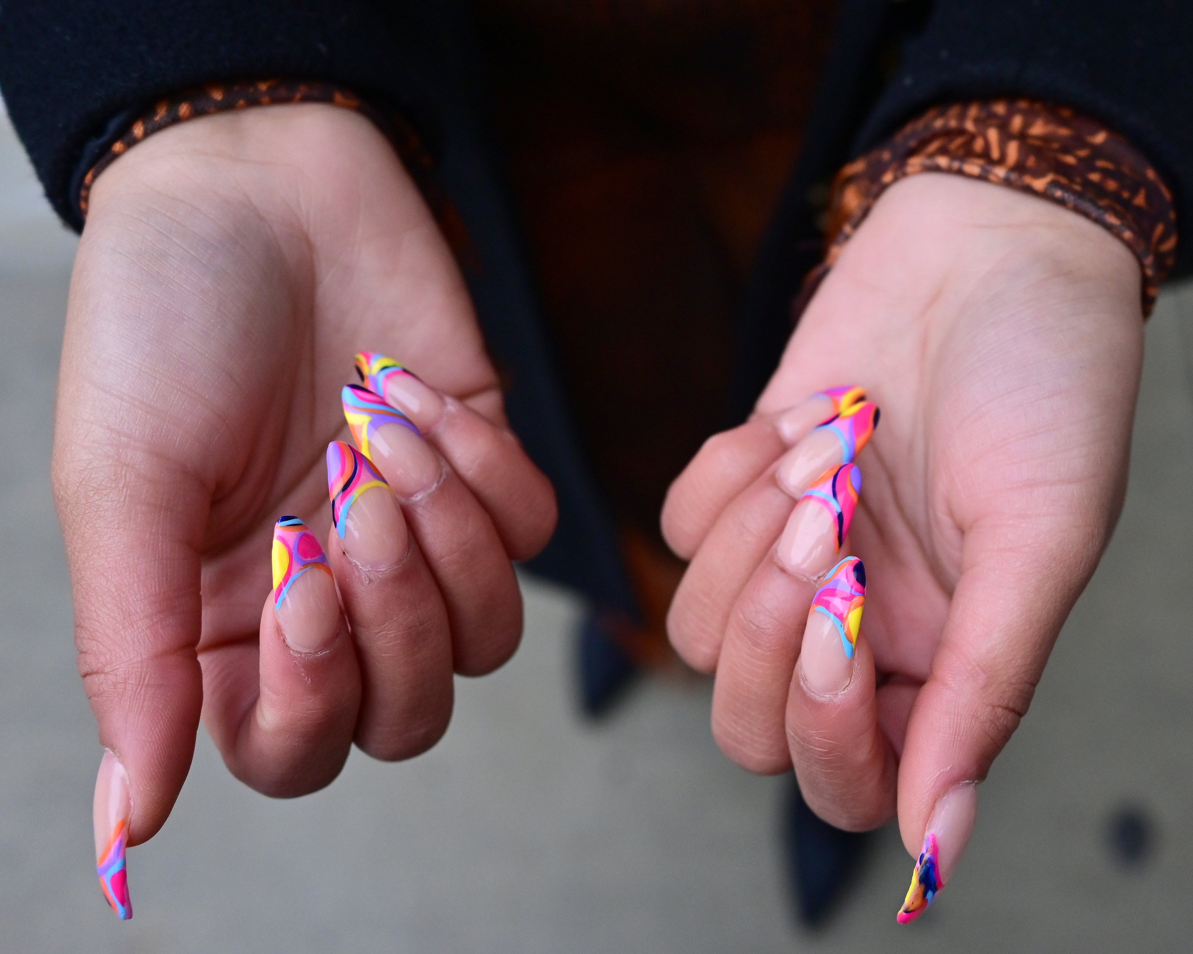 A guest displays graphic, Pucci-inspired nail art at Spring Studios at New York Fashion Week.